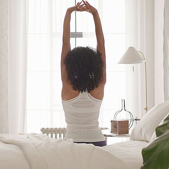 Woman stretching her arms above her head